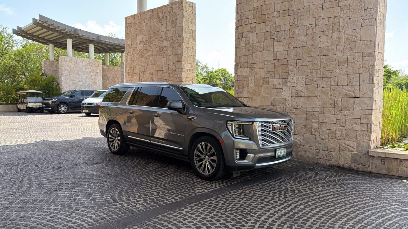 GMC Yukon Denali XL gris de Comfort & Safety Transport en la entrada de un resort de la Riviera Maya